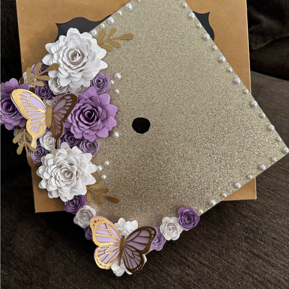 Gold Glitter Graduation Cap with Purple and White Flowers